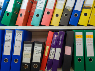 Shelves full of well used office files of various function and sizes.
