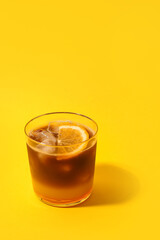Glass of tasty coffee with orange juice on color background