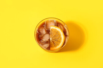 Glass of tasty coffee with orange juice on color background