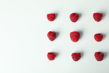 Flat lay composition with  red juicy raspberries on a white background  .
