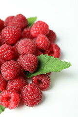 A handful of red juicy raspberries on a white background, close up
