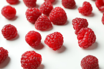 Red juicy raspberries on a white background, close up