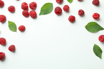 Red juicy raspberries on a white background, space for text