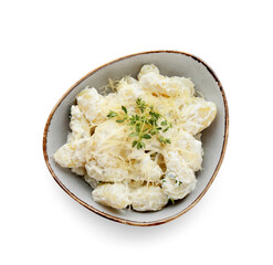 Bowl of delicious gnocchi with creamy sauce on white background