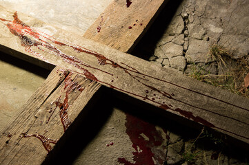 Blood drips on a wooden cross