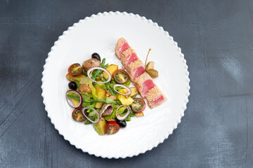 Fried tuna in sesame and salad in a plate