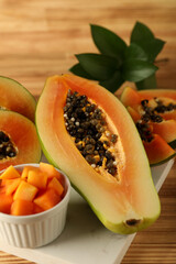 Fresh ripe papaya on light wooden table