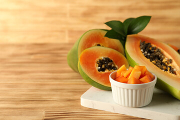 Fresh ripe papaya on light wooden table