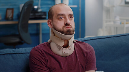 Close up of ill person wearing cervical neck collar against vertebra pain. Man with medical foam...