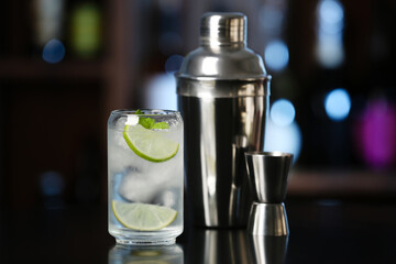 Glass of cold gin tonic on table in bar