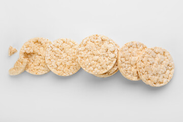 Pile of puffed rice crackers on white background