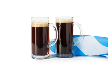 Mugs of fresh beer and Bavarian flag on white background. Oktoberfest celebration