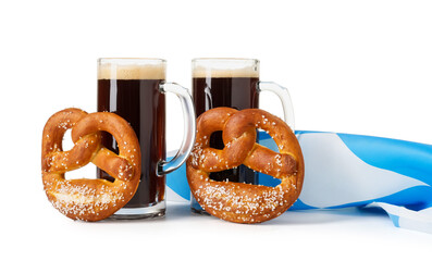 Mug of fresh beer, pretzels and Bavarian flag on white background. Oktoberfest celebration
