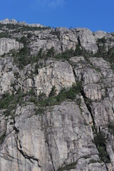White and grey extremely steep granite rock walls of Lysefjord fjord and canyon in Norway in Scandinavia