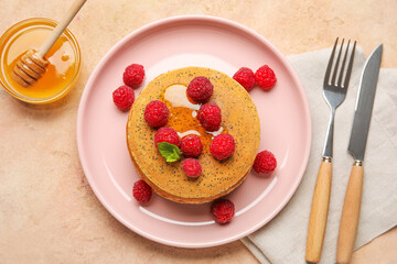 Plate of tasty pancakes with honey and berries on color background