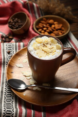 Cup of tasty almond latte on table