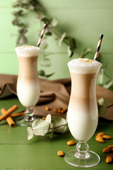 Glasses of tasty almond latte on table