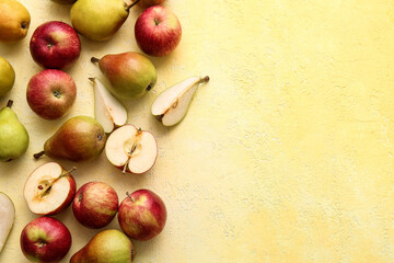 Ripe pears and apples on color background