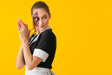 Woman dressed for Halloween as chambermaid on color background