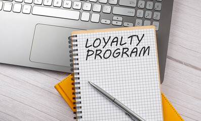 LOYALTY PROGRAM text written on a notebook on the laptop