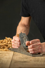 Joinery. Planing a natural oak wood furniture board with a manual planer