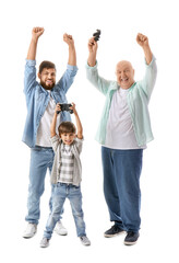 Fototapeta premium Happy man, his little son and father playing video game on white background