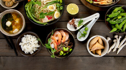Fototapeta na wymiar Asian dishes and snacks on wooden background.
