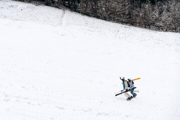 Cross country skating in beautiful winter landscape. Two skiers is walking up the hill. Ski touring in mountains. Cloudy weather. Sport concept