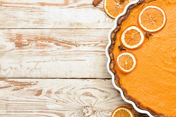 Baking dish with tasty pumpkin pie on white wooden background, closeup