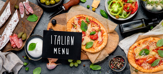 Italian food assortment on dark background.