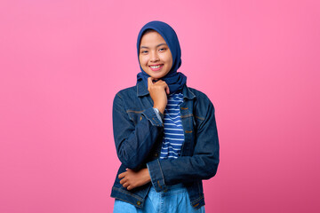 Portrait of happiness young Asian woman looking confident with crossed arm and hand raised on chin