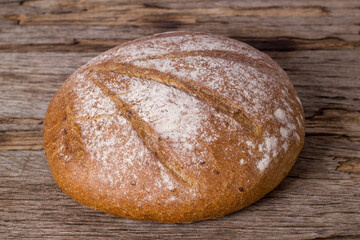 Loaf of buckwheat bread on wooden background