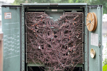 messi telephone lines wires in steel cabinet.