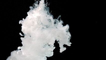 White watercolor ink in water on a black background. Drops of white paints in water.