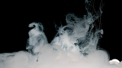 Meditative magic abstract background. White cloud of ink on a black background.