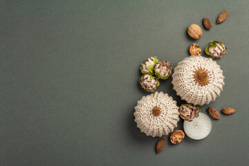 Autumn composition with crocheted pumpkins, candles, spices, and traditional decor