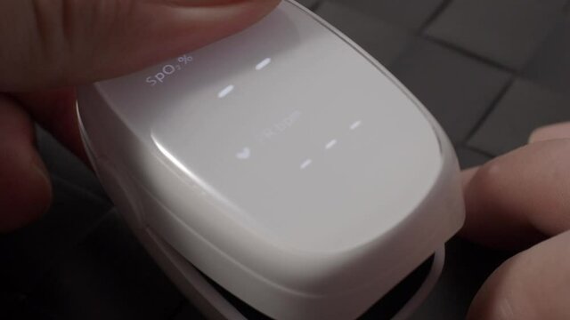 Oximeter usage. Finger pulse oximeter used to measure pulse rate and oxygen levels. Home self care during Covid 19 pandemic. healthcare monitoring concept. using portable fingertip pulse oximeter. 4k