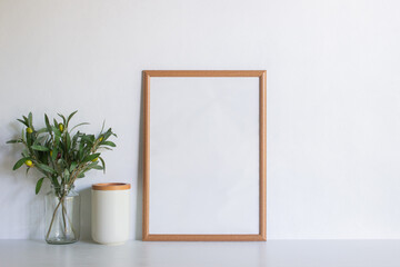 A brown blank frame with flowers over the white background. 