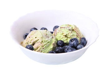 Pistachio ice cream with caramel and blueberry in a plate