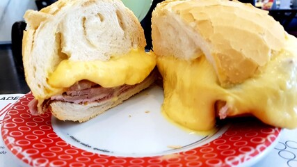 Delicious Snack with melted cheese, roast beef and tomato bread.