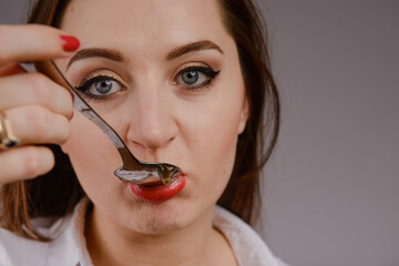 Young woman with red lips and nails in studio