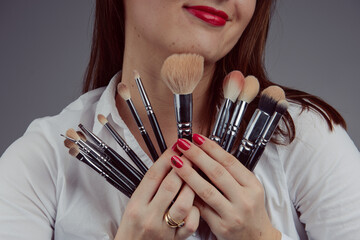 Woman holding a set of cosmetic brushes for make-up,