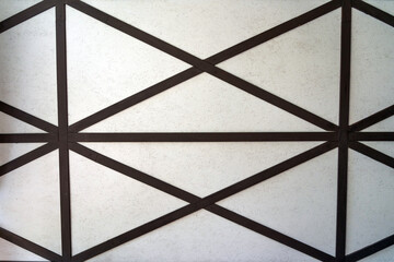 A fragment of a wooden ceiling made of glued plywood and brown boards crosswise