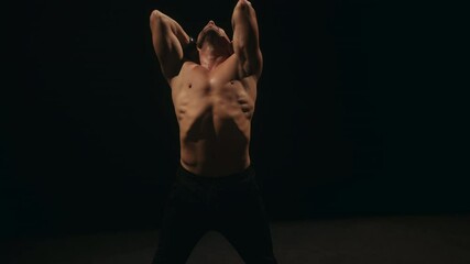 A ballet male dancer is performing choreography on classic theater stage. Choreographer is practicing dance moves. Acrobatic elements of contemporary dance. Performance concept. 4k footage.