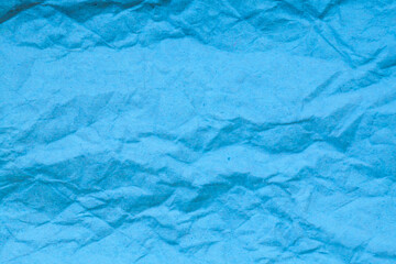 Blue crumpled paper background.