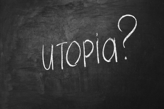 Utopia inscription and question mark written on chalk board