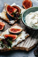 Bowl of cream cheese. Canape or crostini Fig, cream cheese and honey sandwiches. Food recipe background. Close up
