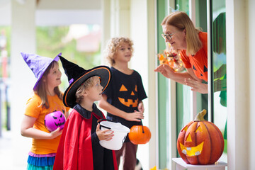 Kids trick or treat. Halloween. Child at door.