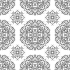 Seamless decorative ornament in ethnic oriental style. Circular pattern in form of mandala and flower for Henna, Mehndi, tattoo, decoration. Doodle outline hand draw vector illustration.