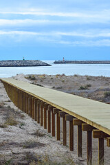 Wood beach walkway with two light houses in the background